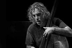 Joe Morris playing the bass in black and white.