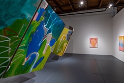 Two paintings hanging from the ceiling.