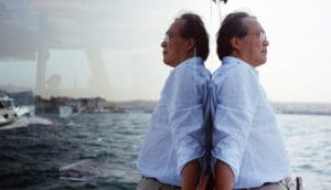 Yo-Yo Ma on a boat, his reflection mirrored in the boat's window