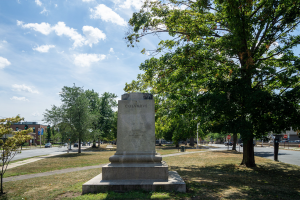 A pedestal that once held a statue of Christopher Columbus in Hartford now sits vacant within a park.