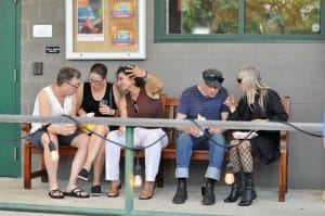 people sitting on a bench having fun