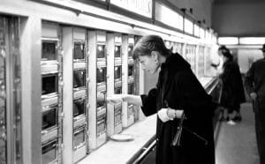 a woman peering into an automat