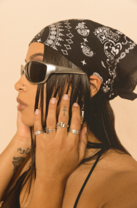 Headshot of DJ Sonia Sol wearing a bandana and sunglasses.