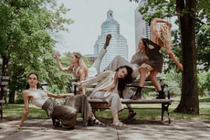 Dancers posing in a park.