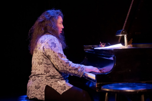 A woman playing the piano.