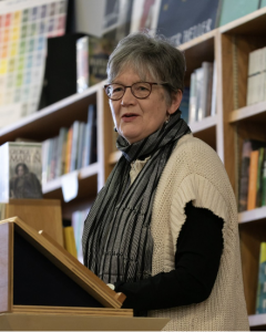 A woman standing at a podium.