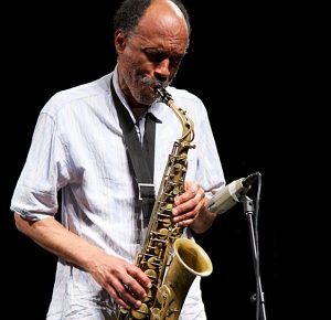 A man playing the saxophone on stage.