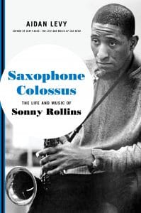 A man holding a saxophone upwards, with text in a bubble that reads "Saxophone Colossus"