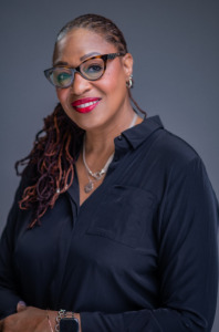  A headshot of a black woman wearing glasses.