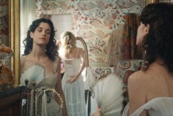 Woman looking at her own reflection in the mirror